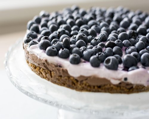 Fresh blueberries in a ceramic bowl on a rustic kitchen counter showcasing a plant-based lifestyle